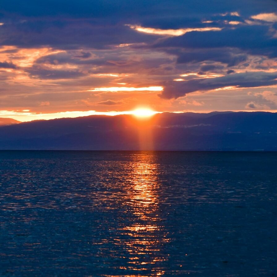 a large body of water under a cloudy sky